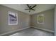 This bedroom features wood-look flooring, modern ceiling fan, neutral paint and plenty of natural light from the double windows at 102 7Th Se Ave, Largo, FL 33771