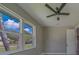 This bedroom features wood-look flooring, neutral paint and plenty of natural light from the double windows and modern ceiling fan at 102 7Th Se Ave, Largo, FL 33771
