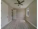 This bedroom features wood-look flooring, modern ceiling fan, neutral paint and plenty of natural light from the double windows at 102 7Th Se Ave, Largo, FL 33771