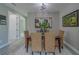 Dining room with seating for six, modern light fixture, and stylish decor at 102 7Th Se Ave, Largo, FL 33771
