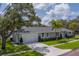 Well-kept home with lush lawn, mature trees and a two-car garage, situated on a desirable corner lot at 102 7Th Se Ave, Largo, FL 33771