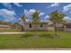 Neat single-story home with a well-kept lawn and simple landscaping, set against a bright blue sky at 102 7Th Se Ave, Largo, FL 33771