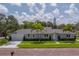 Attractive single-story home with well-maintained lawn and complemented by mature palm trees and lovely brick street at 102 7Th Se Ave, Largo, FL 33771
