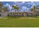 Charming single-story home featuring a manicured lawn and inviting front entrance with bright neutral paint scheme at 102 7Th Se Ave, Largo, FL 33771