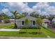 Well-manicured front yard showcases vibrant lawn, complemented by neat shrubbery, small trees, and charming curb appeal at 102 7Th Se Ave, Largo, FL 33771