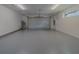View of the home's clean garage, featuring gray flooring, overhead lighting, and garage door at 102 7Th Se Ave, Largo, FL 33771