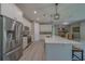 Kitchen with stainless steel appliances, quartz counters, and bar stool seating, opens to dining room at 102 7Th Se Ave, Largo, FL 33771