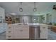 Modern kitchen featuring a large kitchen island, stainless steel appliances and views into the dining and living areas at 102 7Th Se Ave, Largo, FL 33771