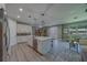 Bright, open kitchen with white cabinetry, stainless steel appliances, and sightlines to the living and dining areas at 102 7Th Se Ave, Largo, FL 33771