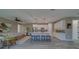 Open concept kitchen with island, counter seating flowing into living room with ceiling fan at 102 7Th Se Ave, Largo, FL 33771