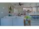 Inviting living room showcasing the modern kitchen with stainless steel appliances and white cabinetry at 102 7Th Se Ave, Largo, FL 33771