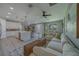 Bright, open-concept living room and kitchen featuring a large sectional sofa and center island with seating at 102 7Th Se Ave, Largo, FL 33771