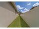View of the grassy side yard and partial fencing running along the home's exterior at 102 7Th Se Ave, Largo, FL 33771