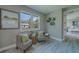 Cozy sitting area with patterned chairs, bright windows, and decorative wall art adding a touch of elegance at 102 7Th Se Ave, Largo, FL 33771