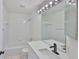 Bright bathroom with a shower and tub combination and a modern quartz countertop vanity at 10414 Hallmark Blvd, Riverview, FL 33578