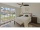 A bright bedroom with a large window offering an outside view, and stylish ceiling fan at 10414 Hallmark Blvd, Riverview, FL 33578