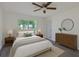 Cozy bedroom with neutral walls, wood-look floors, and natural light from a large window at 10414 Hallmark Blvd, Riverview, FL 33578