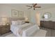 Comfortable bedroom featuring neutral decor, hardwood floors, and lots of natural light from the windows at 10414 Hallmark Blvd, Riverview, FL 33578