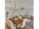 Open-concept living and dining area with hardwood floors, modern lighting, and comfortable seating at 10414 Hallmark Blvd, Riverview, FL 33578