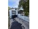 White home with a black trimmed and a driveway at 1107 Grant St, Clearwater, FL 33755