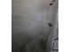 Updated shower with tiled walls and floor and modern shower head at 1107 Grant St, Clearwater, FL 33755