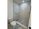 Modern bathroom featuring shower with pebble tile floor and marble look at 1109 N Obrien St, Tampa, FL 33607