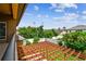 Balcony view overlooking the backyard featuring a pergola, lush landscaping, and fencing at 11407 Drifting Leaf Dr, Riverview, FL 33579