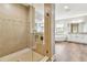 Stunning bathroom with a glass shower, soaking tub, and dual vanities with granite countertops at 11407 Drifting Leaf Dr, Riverview, FL 33579