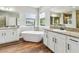 Luxurious bathroom featuring a soaking tub, granite countertops, and dual vanities at 11407 Drifting Leaf Dr, Riverview, FL 33579
