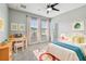 Cozy bedroom with a ceiling fan, natural light, and a comfortable work space at 11407 Drifting Leaf Dr, Riverview, FL 33579