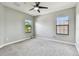Empty bedroom with neutral walls and carpet, windows, and a ceiling fan at 11407 Drifting Leaf Dr, Riverview, FL 33579