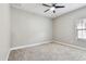 Empty bedroom with neutral carpet and paint with a single window providing natural light at 11407 Drifting Leaf Dr, Riverview, FL 33579