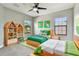 Bright bedroom featuring two twin beds, natural light and a fun aesthetic at 11407 Drifting Leaf Dr, Riverview, FL 33579