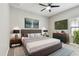 This bedroom is fully furnished with decorative bedside lamps and a gray bed frame at 11407 Drifting Leaf Dr, Riverview, FL 33579