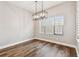 Dining room with modern light fixture and large windows with hardwood floor at 11407 Drifting Leaf Dr, Riverview, FL 33579