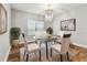 Elegant dining room with a glass table and stylish chandelier at 11407 Drifting Leaf Dr, Riverview, FL 33579