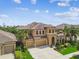 Stunning two-story home with a three-car garage and professionally landscaped front yard at 11407 Drifting Leaf Dr, Riverview, FL 33579