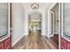 Welcoming foyer with hardwood floors and an open view of the staircase at 11407 Drifting Leaf Dr, Riverview, FL 33579