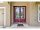 Elegant double front doors with decorative glass and a welcoming doormat at 11407 Drifting Leaf Dr, Riverview, FL 33579