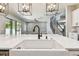 Open concept kitchen with island, farm sink, faucet, and pendant lighting overlooking living space at 11407 Drifting Leaf Dr, Riverview, FL 33579