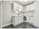 Kitchenette area with white cabinets, dark hardware, and a butcher block countertop at 11407 Drifting Leaf Dr, Riverview, FL 33579