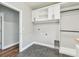 Spacious laundry room area with upper cabinets and wash and dryer hookups at 11407 Drifting Leaf Dr, Riverview, FL 33579