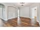Bright living room with modern ceiling fan, wood flooring, and arched doorway at 11407 Drifting Leaf Dr, Riverview, FL 33579