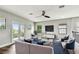 Living room has modern furnishings and large windows for ample natural light and a balcony entrance at 11407 Drifting Leaf Dr, Riverview, FL 33579