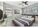 Cozy primary bedroom featuring a ceiling fan, large window, and plush carpeting at 11407 Drifting Leaf Dr, Riverview, FL 33579