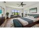 Spacious primary bedroom with a ceiling fan, seating area, and access to a balcony at 11407 Drifting Leaf Dr, Riverview, FL 33579