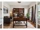 Cozy home office with a built-in bookshelf and leather furniture at 11407 Drifting Leaf Dr, Riverview, FL 33579