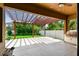 Beautiful outdoor patio with a pergola, lush greenery, and a built-in grill at 11407 Drifting Leaf Dr, Riverview, FL 33579