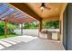 Inviting outdoor patio with a pergola, a built-in grill, and views of the green backyard at 11407 Drifting Leaf Dr, Riverview, FL 33579