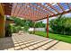 Outdoor patio with a wood pergola offering shade and beautiful backyard views at 11407 Drifting Leaf Dr, Riverview, FL 33579